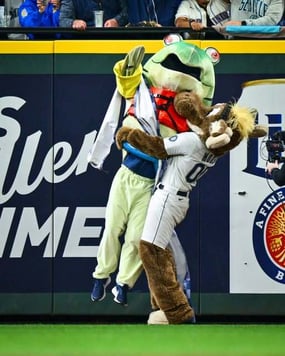 Humpy the salmon jumping into the arms of Mariners moose after his famous win (Creator: Jane Gershovich 
| 
Credit: MLB Photos via Getty Images
Copyright: 2025 Major League Baseball Photos) https://www.facebook.com/share/p/1AFk8tfxkj/